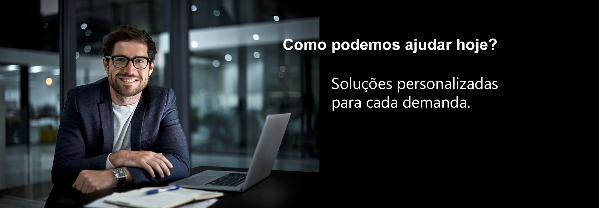 Portrait of a happy young businessman working at his office desk